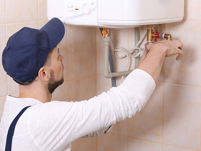Plumber Fixing Water Heater
