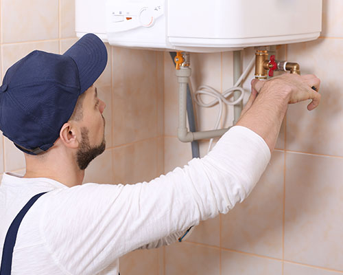 Man fixing water heater